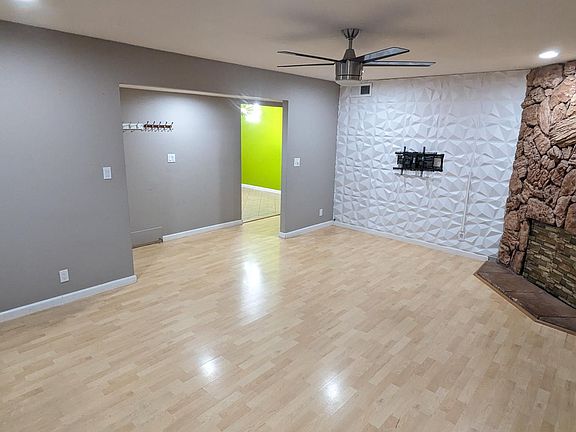 Living Room with 3D wall, TV mount, Fireplace, fan and recessed lights
