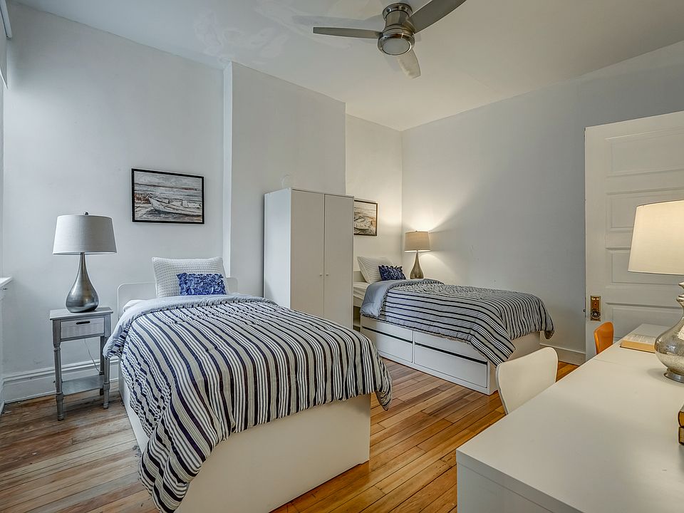 Large second bedroom, two desks, and ceiling fan.