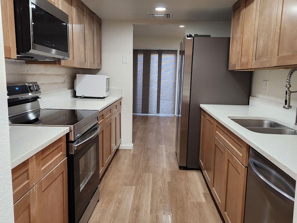 Galley kitchen looking towards living room from dining area