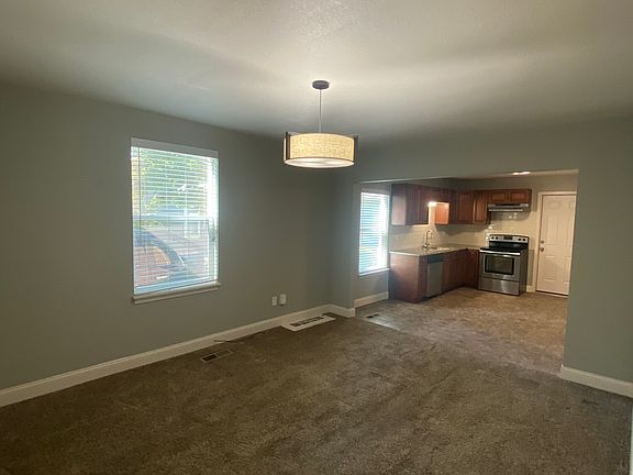 Walk into large living area, lots of natural light and connected kitchen area.
