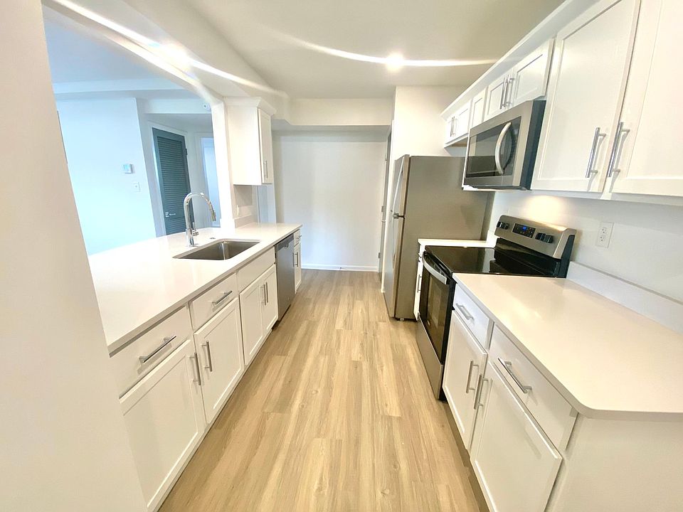 Fully equipped kitchen with stainless steel appliances. Refrigerator, stove, dishwasher, and garbage disposal included. Quartz countertops.