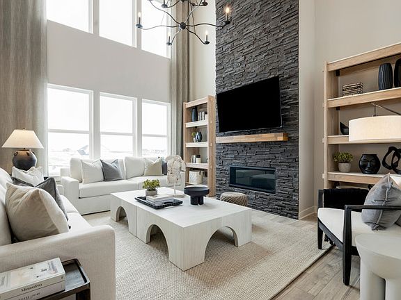Gorgeous Vaulted Gathering Room with Floor To Ceiling Stone Accent on Fireplace