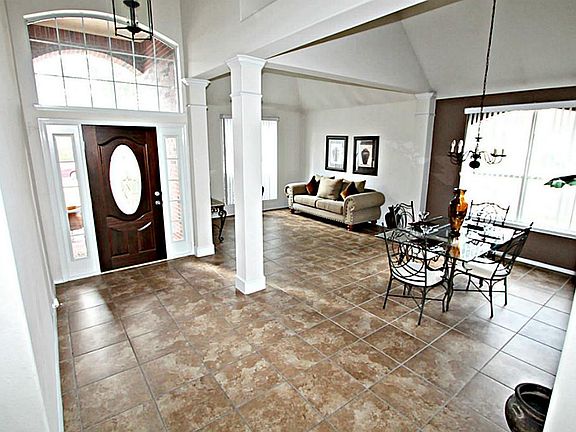 STEP INSIDE TO THE BRIGHT SOARING FOYER WITH UPGRADED TILE FLOORS