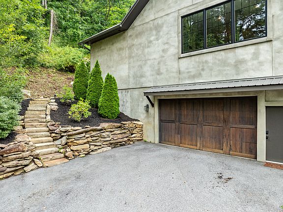 Front of house. The steps on the left wind around to the back of the house where the back patio/coi pond is