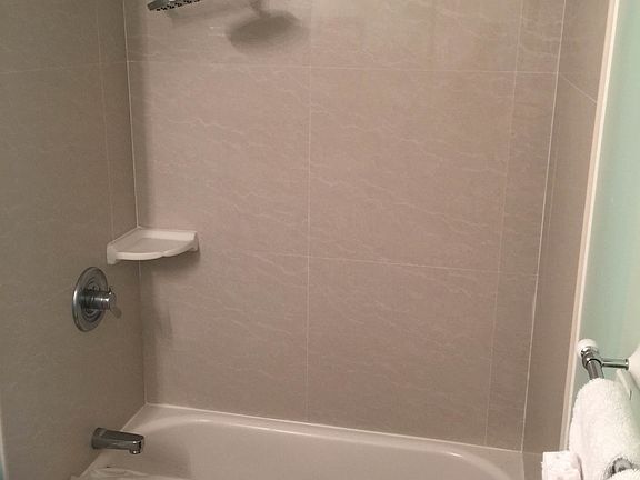 Bathtub with refinished shower