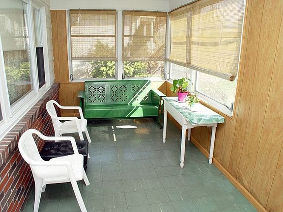 Three-season enclosed porch for additional living space.