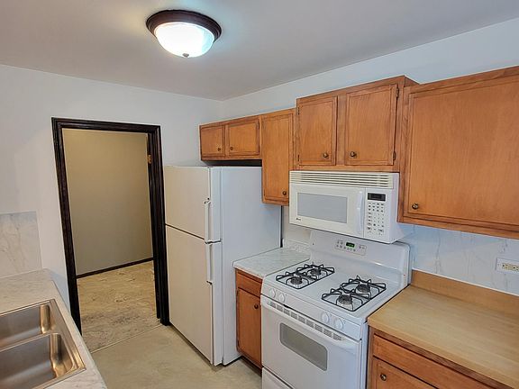 Refrigerator, microwave and gas stove all included. All appliances are like new. Very clean kitchen. Door leads to Utility/Laundry/Storage Room - great for pantry space!
