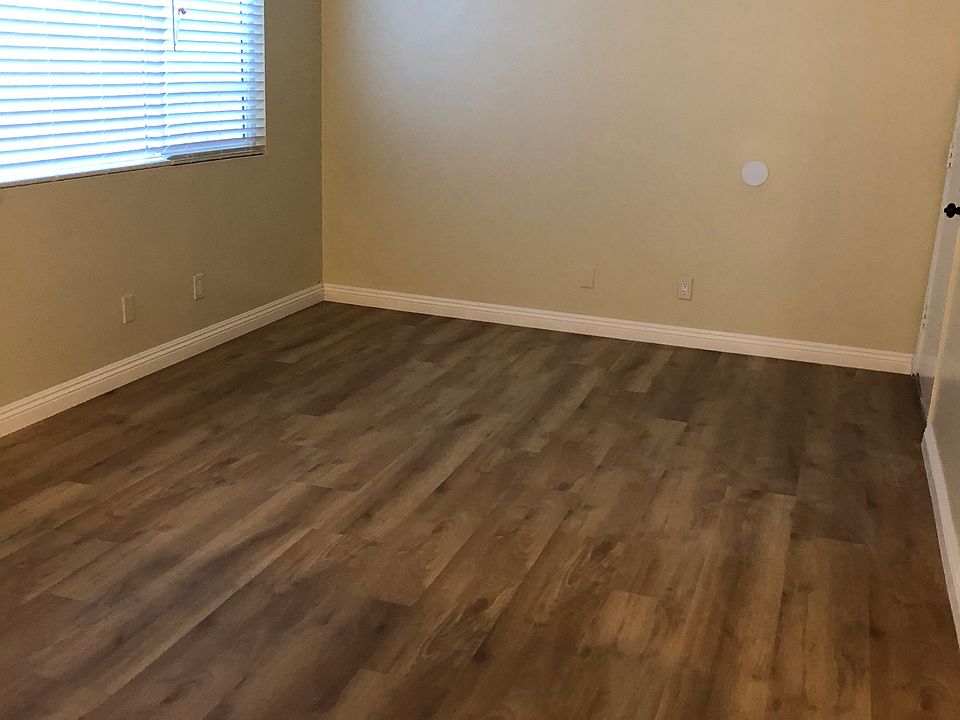 large Living Room with new laminate floor and crown baseboard, Venetian Blinds and newly painted