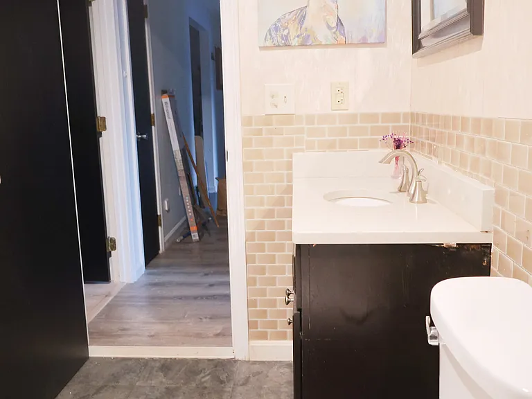 Bathroom _ Fully Renovated Within the Past Year, Featuring a New Tub, Toilet, Sink, Flooring, Wallpaper, and Cabinetry.