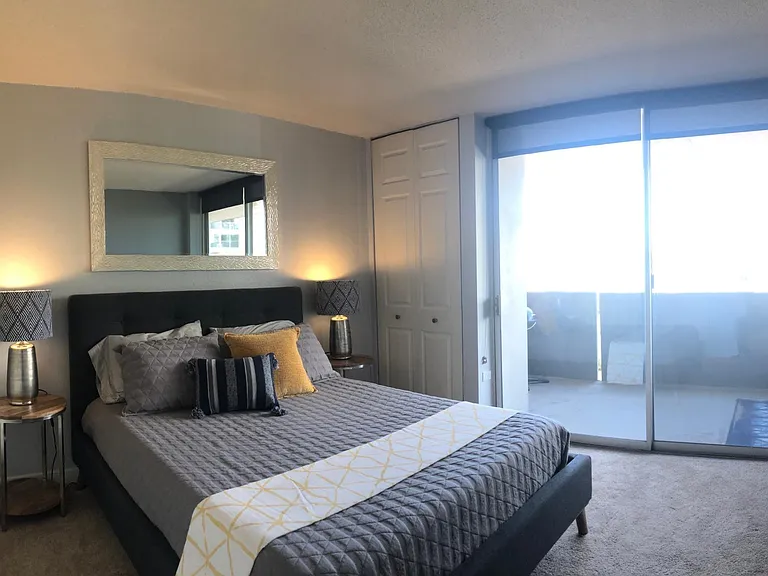 Relaxing bedroom with modern decor and balcony access.
