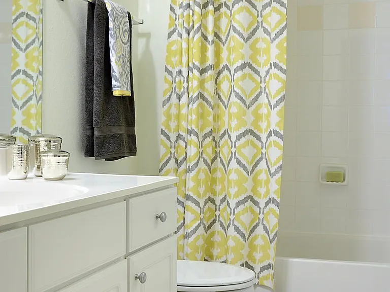 Classic I bathroom with white cabinetry, white countertop, and tile flooring