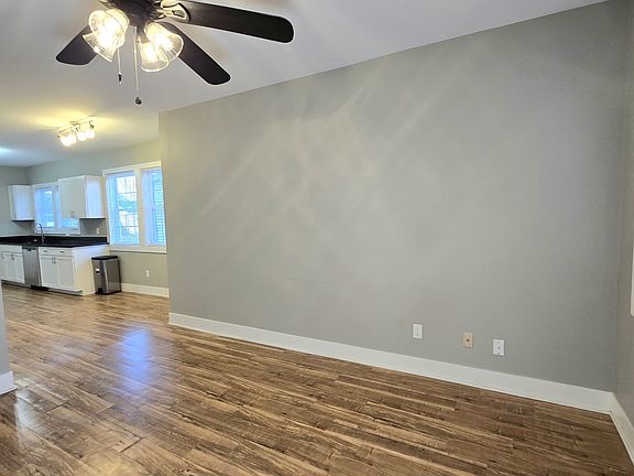Standing in the living room looking at the eating area in the kitchen.