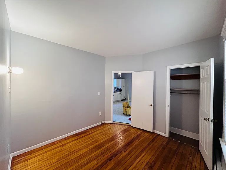 Bedroom 2 with closet, wall sconce light and outlet for wall mounted TV