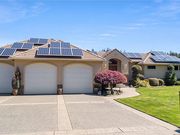 Parking for four vehicles inside garage with ample parking on the over sized stamped concrete driveway. Solar panels will help keep energy costs down.