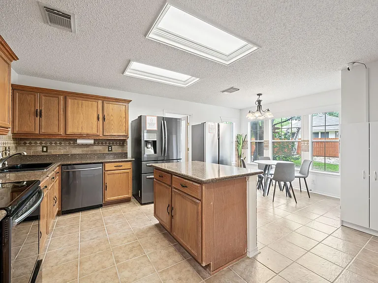 Large Kitchen with Multiple Refrigerators and Plenty of Storage