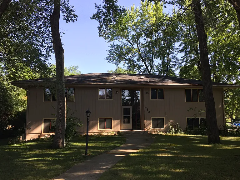 Four-plex from parking lot & garage perspective. Unit C is the upper right condo. It faces south and east.