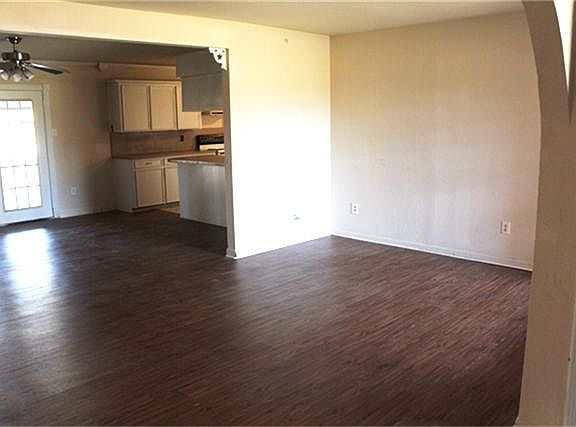 LIVING AREA WITH BRAND NEW VINYL PLANKED FLOORING AND FRESH PAINT