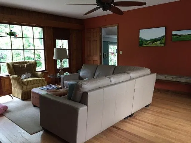 Living Room - wall no longer brick red but is now a neutral color. Windows look out toward the back yard.