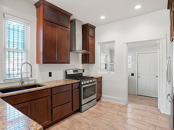 Updated kitchen with granite counters, newer cabinets, stainless appliances and a gas range