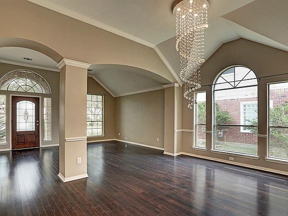 Enter the inviting etched glass front door into the beautiful living/formal dining with archways.
