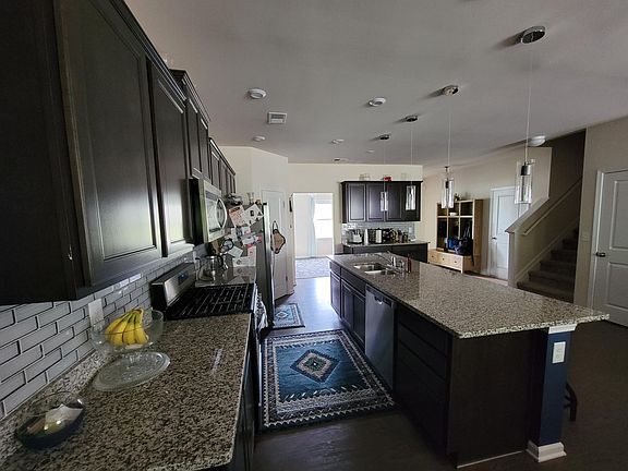 Entire kitchen. Left door to dining room and opening to the right is hallway to front door.