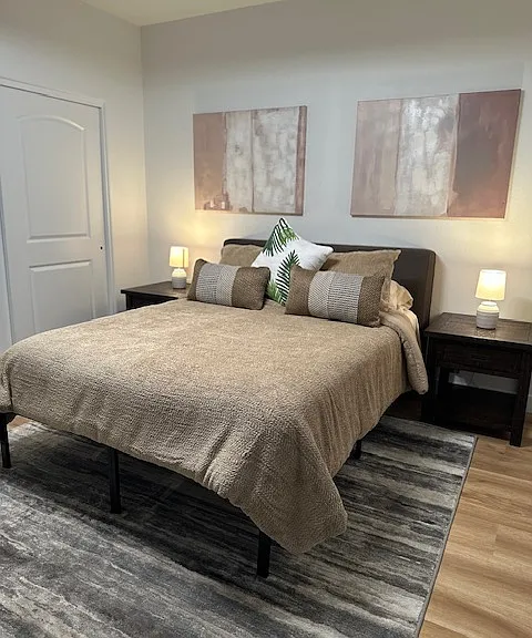 Master Bedroom with Dresser and Standing desk.