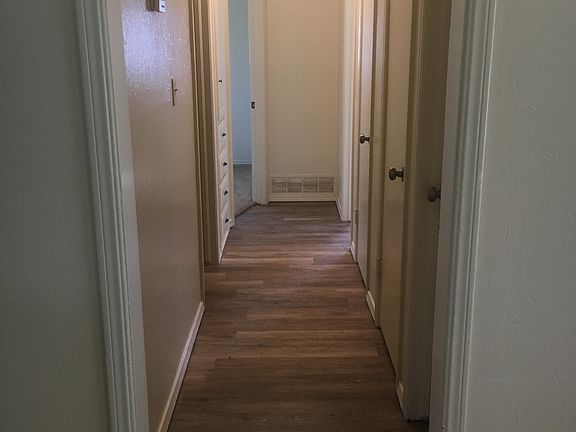 Hall way with three storage closets