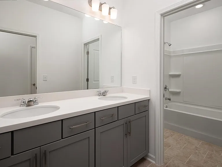 Secondary suite bathroom with a tub and shower combination