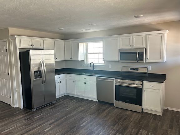 Kitchen with soft closing doors and stainless steel appliances