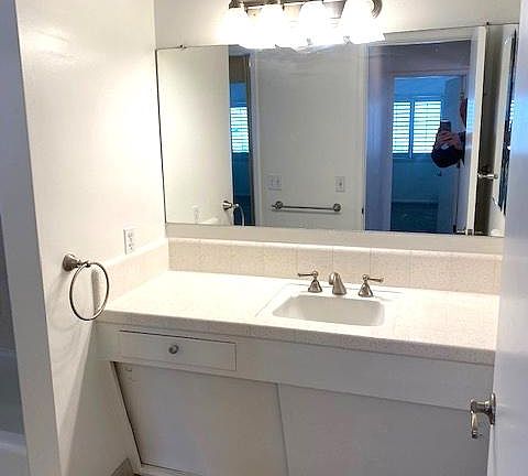 Single sink vanity with adequate storage space on the counter top and below.