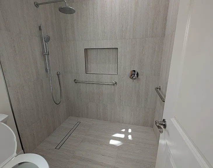 handicap master shower. Elegance of marfil stone with ease of care and cleaning of a premium porcelain tile.