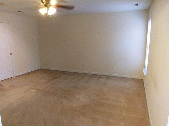 Huge master bedroom with ceiling fans and a large walk in closet