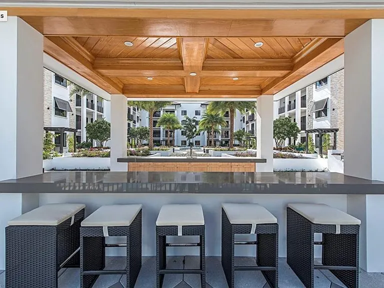 Spacious courtyard with grills, fire pit, and pavilion bar