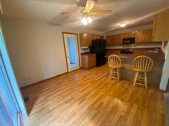 Kitchen & dining area. Counter seating & plenty of room for a table under a ceiling fan w/light.