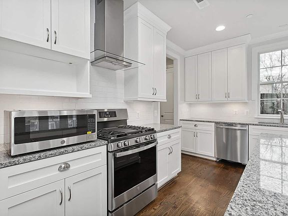 Range wall, hood, cabinetry floor to ceiling