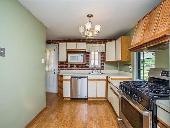 The kitchen is super clean with stainless steel dishwasher & stove as well as hardwood flooring.
