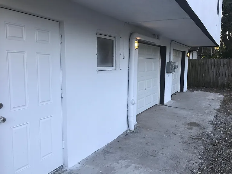 Exterior Car Garage entrance on left is Apartment B, Right is Apartment A