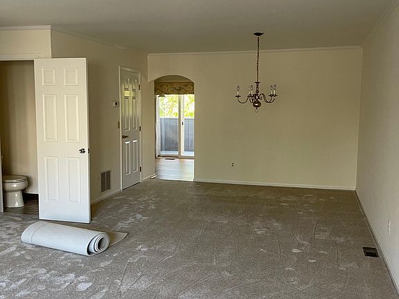 Living room flows into kitchen with deck