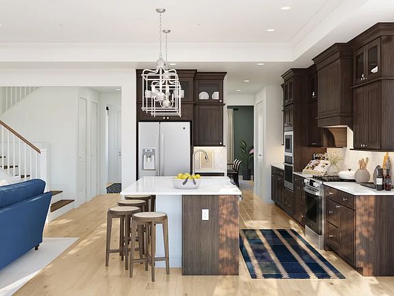 Kitchen with glass upper cabinets and brushed nickel pendant lighting