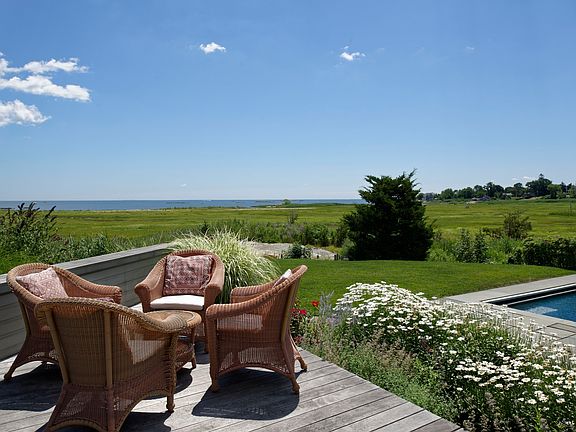 Enjoy the sunshine, perennial gardens and unobstructed water views from the uncovered portion of the extensive (Ipe) deck measuring 15x17.