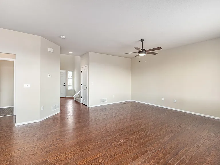 Living room with 1/2 bath to the left (background) & entry (right background)