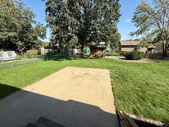 Picture from steps of landscaped backyard. Has small shed.