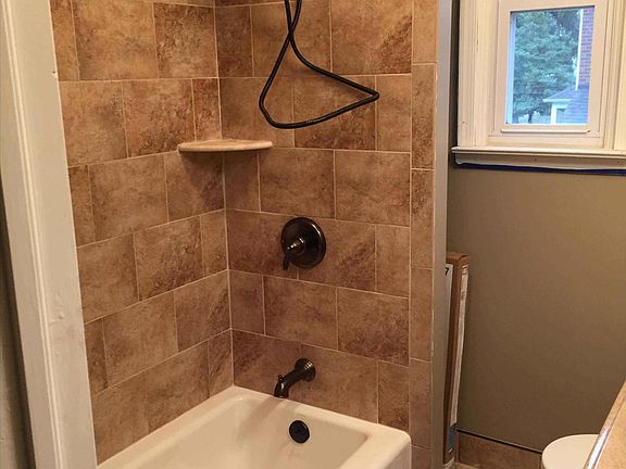 Upstairs bathroom with tub and shower