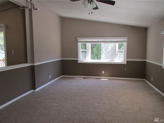 There is a half wall separating the kitchen dining area from the living room. All windows are new vinyl.