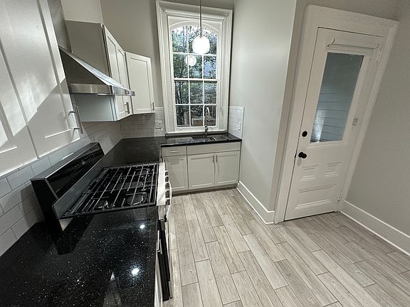 Fully renovated kitchen with granite countertops and all-new stainless steel appliances