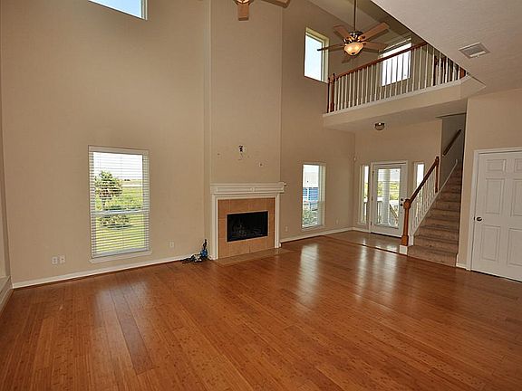 Living room with soaring ceilings, fireplace and beautiful wood floors