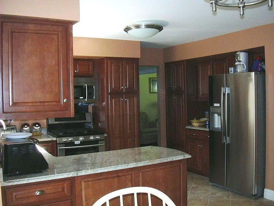 New Kitchen with Honey Maple Cabinet and Porcelain Floors