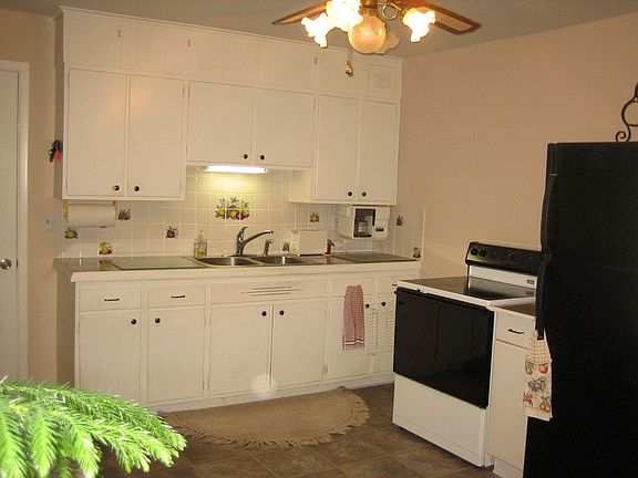 Crisp white kitchen open to dining area