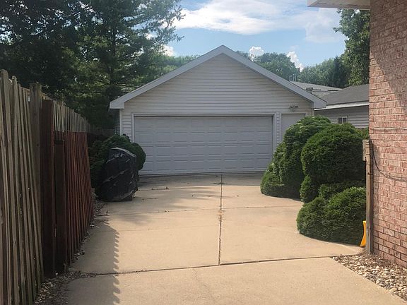 2 car detached garage with private driveway and rolling fence to close off access to the back of the property for privacy