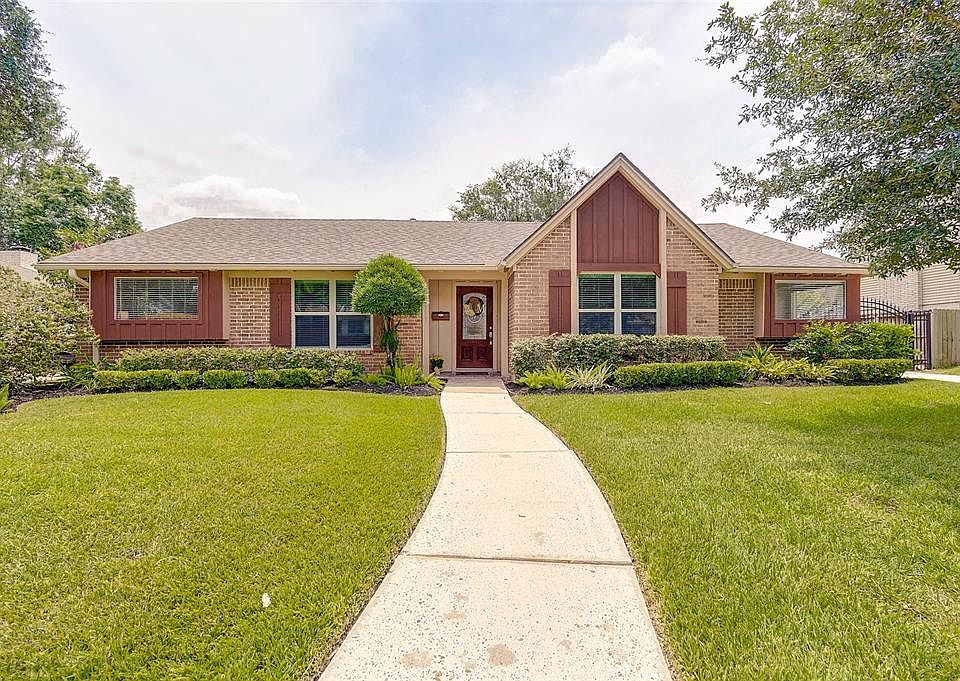 WOW! Welcome Home! Front of this lovely home with lots of character and recent roof. Wrought iron driveway gate as well.